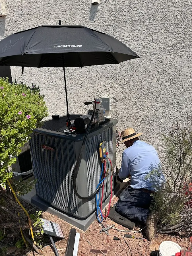 HVAC technician performing outdoor AC maintenance in Marietta